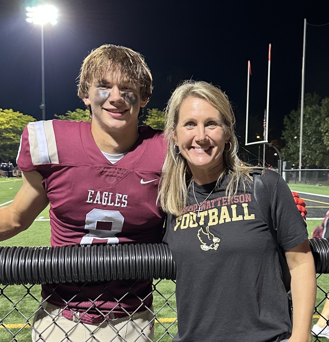 Jake and Angie Uhlenhake pose for a photo following a Bishop Watterson football game.